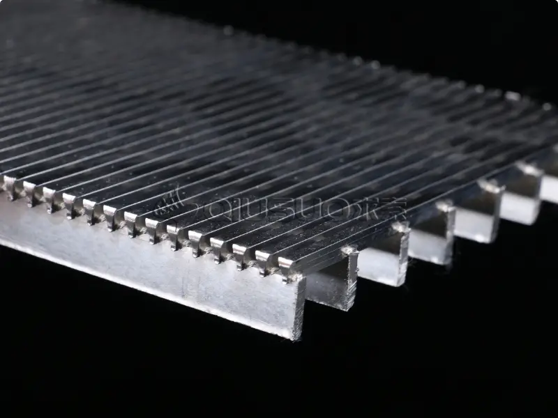 A wedge wire plate on black background.