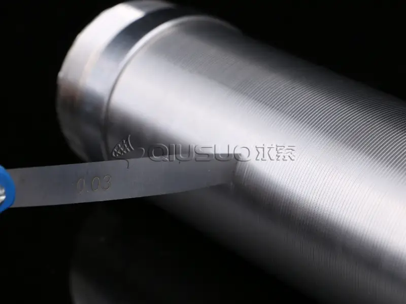 A detail of 0.03 micron slot size wedge wire tube on black table.