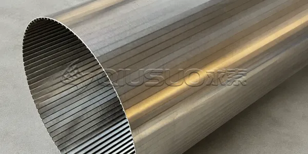 A worker is inspecting the detailed parts placed in the wedge screen cylinder.