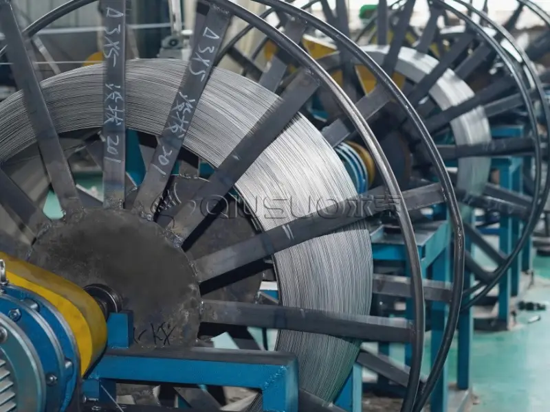 Several reels of wedge wire materials on production line