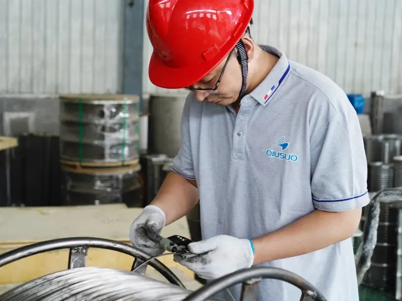 A worker is testing the raw material diameter.