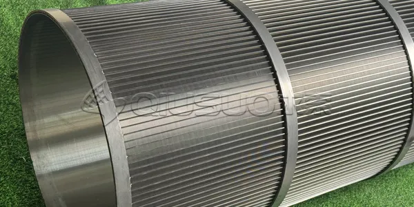 A finished wedge wire screen cylinder on the green grassland.