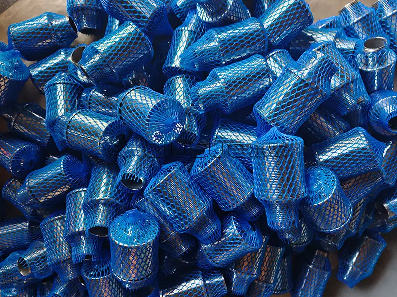 Many wedge wire screen nozzles in nylon mesh packaging sleeves