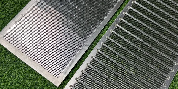 The finished wedge wire screen panels are placed on the green grass.