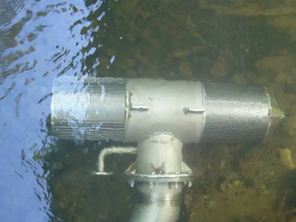 A wedge wire T-intake screen is submerged under water for water intake.